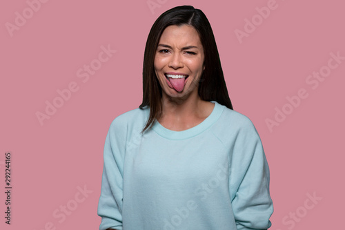 Woman making funny goofy face with tongue out, expressive comedic asian american фототапет