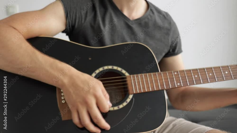 Medium close up of a man playing his guitar.J.A Medium close up of a man playing his guitar.J.A