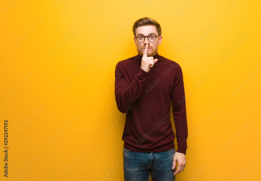 Young smart man keeping a secret or asking for silence Young smart man keeping a secret or asking for silence