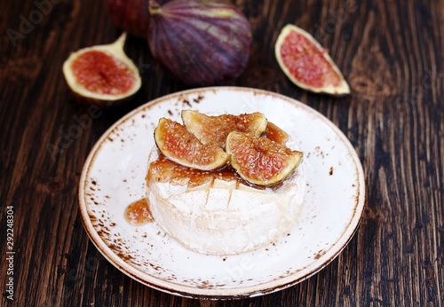 Baked Camembert cheese with figs . copy space