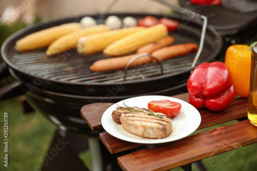 Barbecue grill with tasty fresh food outdoors, closeup