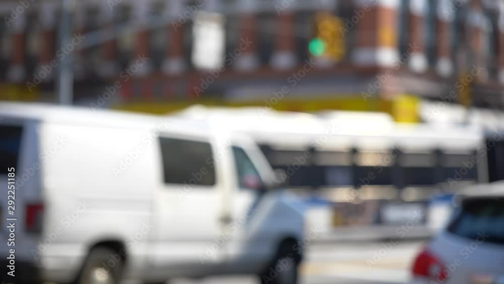 Out of focus white van passing bus in NY city Out of focus white van passing bus in NY city