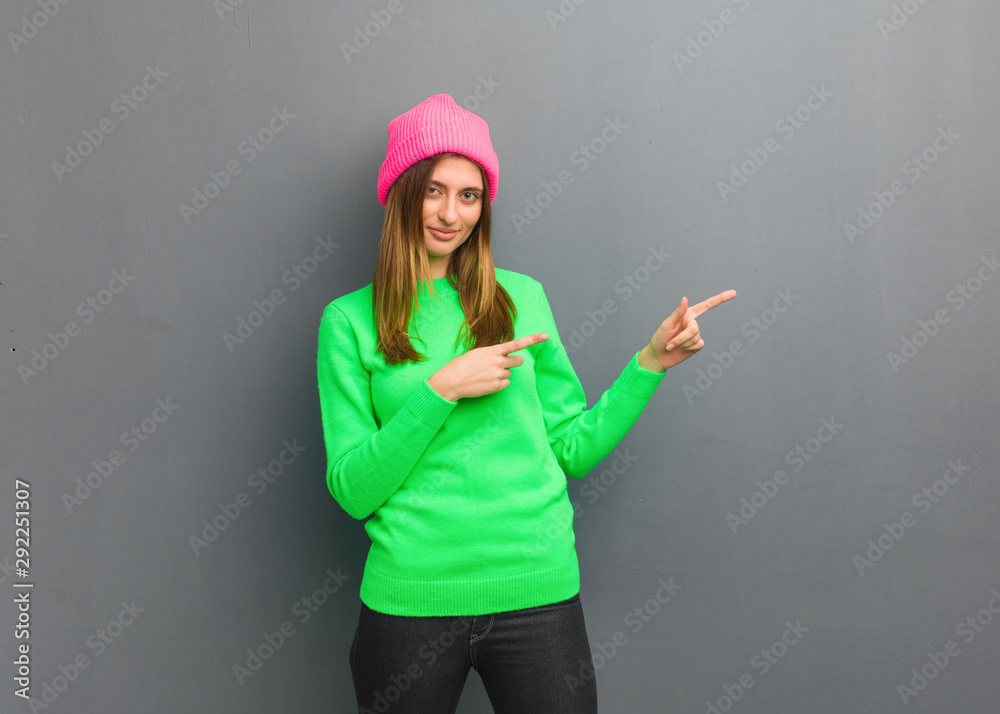 Young natural russian girl pointing to the side with finger Young natural russian girl pointing to the side with finger