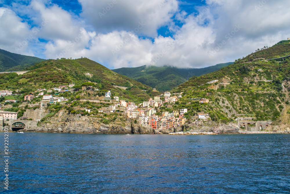 Riomaggiore, Cinque Terre, Italy - August 17, 2019: Village by the sea bay, colorful houses on the rocky coast. Nature reserve resort popular in Europe