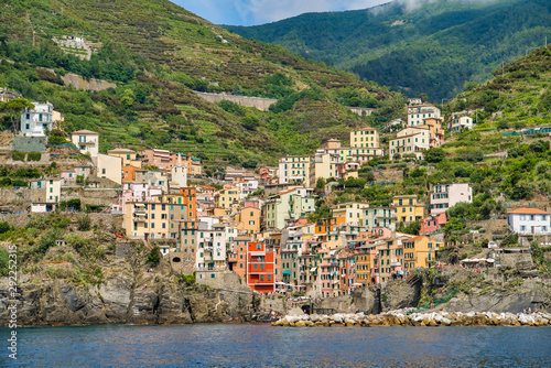 Obraz na płótnie Riomaggiore, Cinque Terre, Italy - August 17, 2019: Village by the sea bay, colorful houses on the rocky coast. Nature reserve resort popular in Europe w salonie