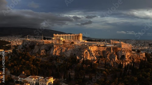 Aerial rising shot of the famous Parthenon temple and Acropolis at sunset. Athens, Greece