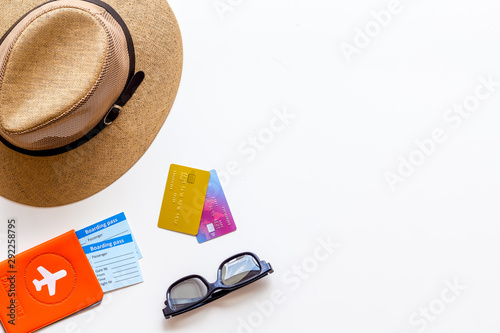 Tourist concept. Passport with airplane, tickets, hat, glasses on white background top view copy space frame