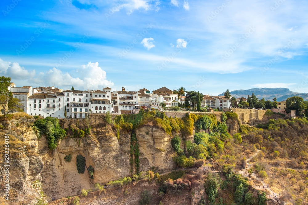 Famous Ronda restaurants and colonial houses overlooking the scenic gorge and the Puente Nuevo bridge