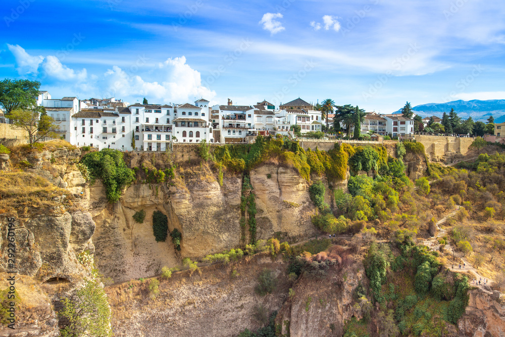 Famous Ronda restaurants and colonial houses overlooking the scenic gorge and the Puente Nuevo bridge