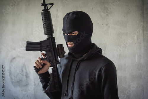 Portrait robbery man standing is holding M16 gun on hand