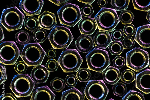 top view of shiny diverse metal nuts isolated on black