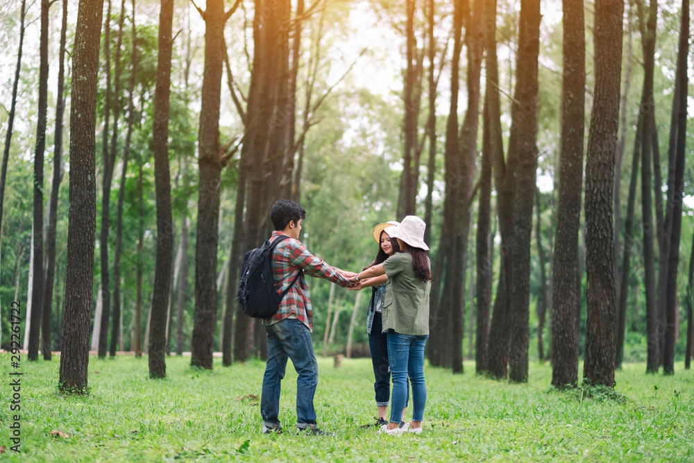 Closeup image of travelers putting their hands together in the forest Closeup image of travelers putting their hands together in the forest
