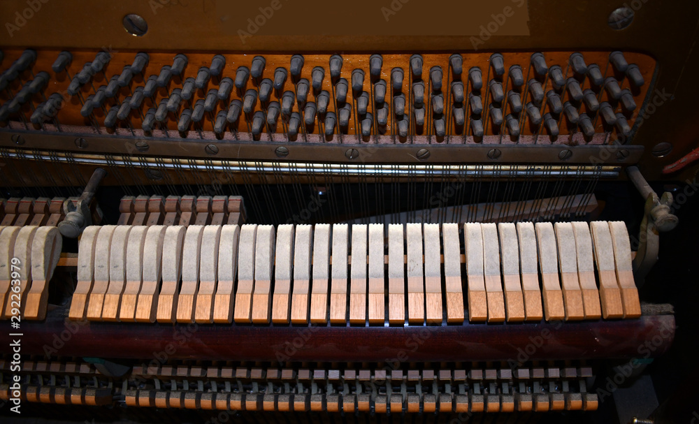 CLOSE UP Detail of dusty hammers striking string inside the old destroyed piano CLOSE UP Detail of dusty hammers striking string inside the old destroyed piano