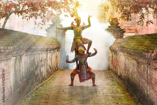 Khon is art culture Thailand Dancing in masked Ramakien ,Hanuman and tos-sa-kan are Dancing in literature Ramayana.Khon is thailand culture and traditional sunlight background. photo