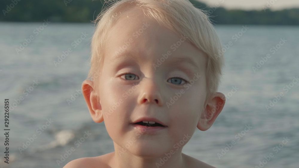 Closeup portrait of cute child (little boy, two years old kid) on beach. Caucasian, blonde hair, blue eyes. Closeup portrait of cute child (little boy, two years old kid) on beach. Caucasian, blonde hair, blue eyes.
