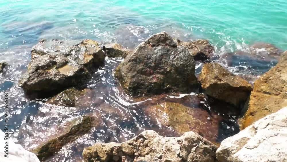 On a rocky shore of the sea. Waves roll with noise onto a rocky shore. Beautiful seascape. Rocky shore of a peaceful ocean. Waves beat against the shore. On a rocky shore of the sea. Waves roll with noise onto a rocky shore. Beautiful seascape. Rocky shore of a peaceful ocean. Waves beat against the shore.
