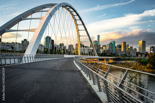 Edmonton, Alberta, Canada skyline at dusk with suspension bridge in foreground and clouds  photo
