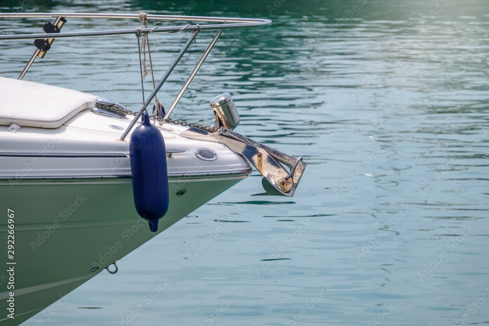 Fototapeta premium The bow of a yacht with an anchor on a background of sea water.