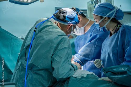 Medical team performing surgical operation in operating Room