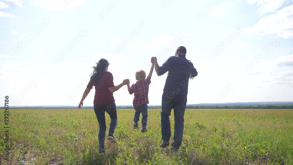 happy family runs nature teamwork friendship care concept slow motion video. father mom and son running in nature sunset sunlight hold hand. happy family parents man lifestyle and girl hold little boy happy family runs nature teamwork friendship care concept slow motion video. father mom and son running in nature sunset sunlight hold hand. happy family parents man lifestyle and girl hold little boy