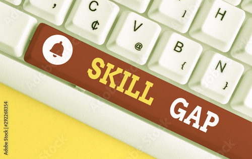 Text sign showing Skill Gap. Business photo showcasing Refering to a demonstrating s is weakness or limitation of knowlege White pc keyboard with empty note paper above white background key copy space photo
