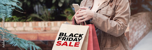 young women carrying shopping bags and shopping online, Black friday sale concept