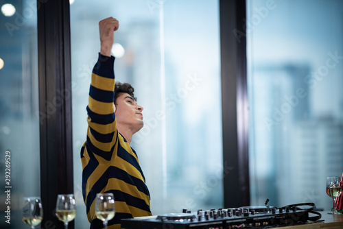 Male DJ playing music in party