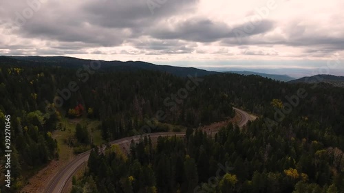 Aerial view of road stretching through leaves changing in the forest. photo