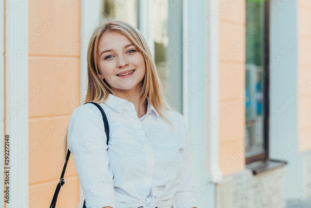 Portrait from back of elegant girl with long hair walking on steer on old building background. Portrait from back of elegant girl with long hair walking on steer on old building background.