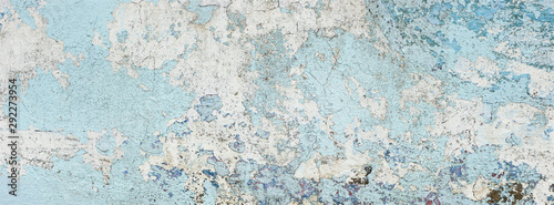 very old and dirty light blue paint texture peeling off the concrete wall for banner background