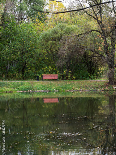 Autumn, bench by the pond.