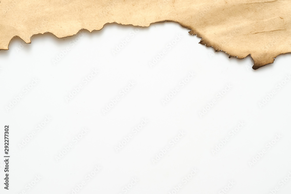 Cropped shot of old beige paper with burnt edge on white background. Decorative abstract art design. Copy space.