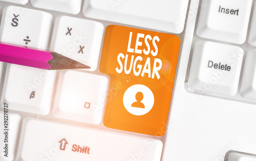 Conceptual hand writing showing Less Sugar. Concept meaning Lower volume of sweetness in any food or drink that we eat White pc keyboard with note paper above the white background photo