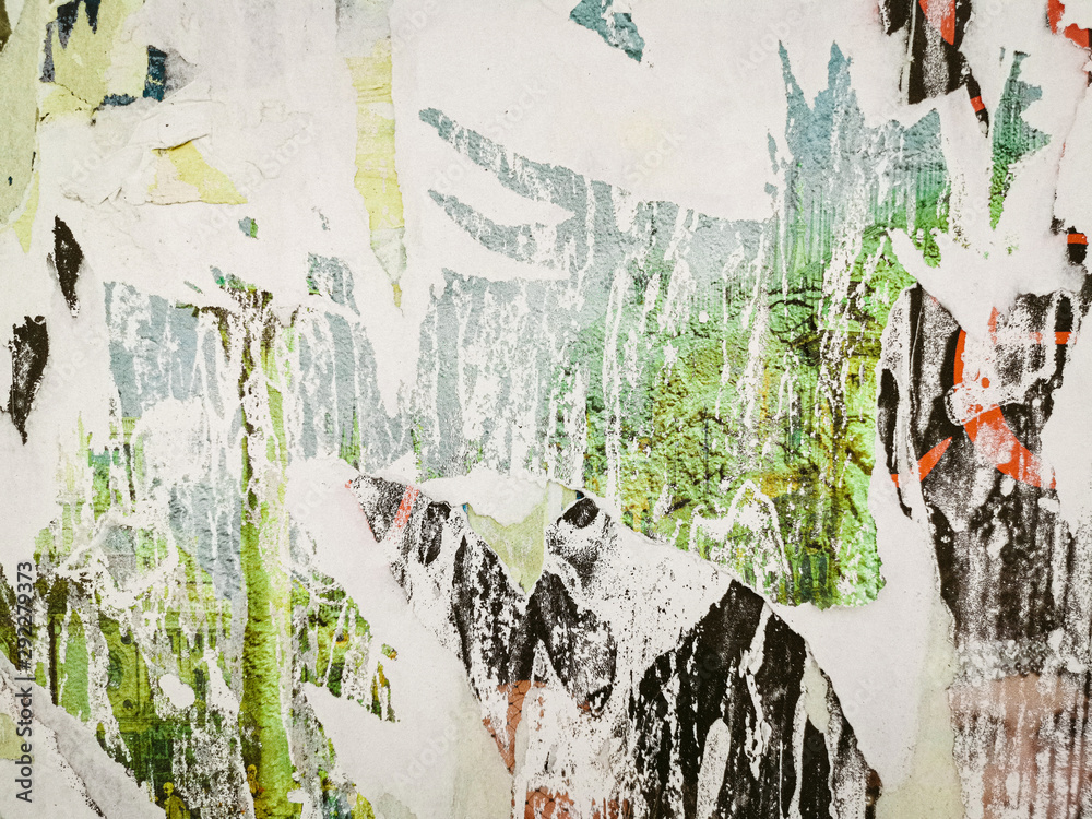 Fototapeta premium Layers of old colorful posters on wall damaged by time for your grunge style design