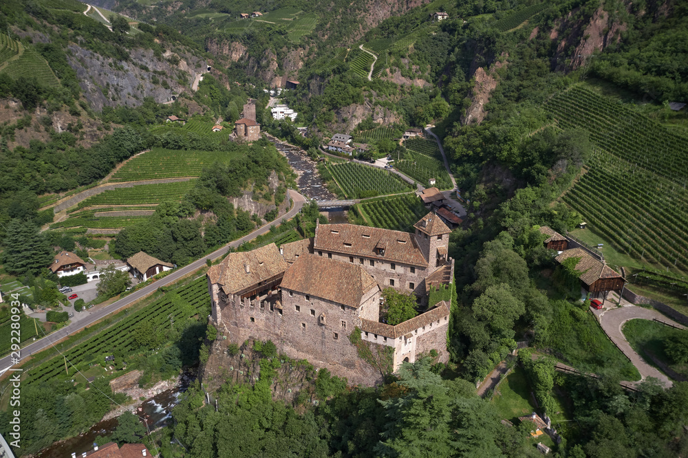 Aerial view of vineyards in the Alps. Flying on drone. House on the rock.