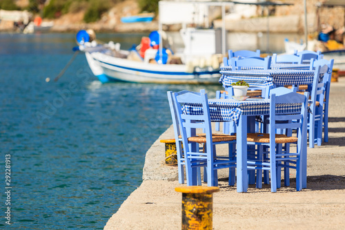 Fototapeta Naklejka Na Ścianę i Meble -  Open cafe outdoor restaurant in Greece on sea shore