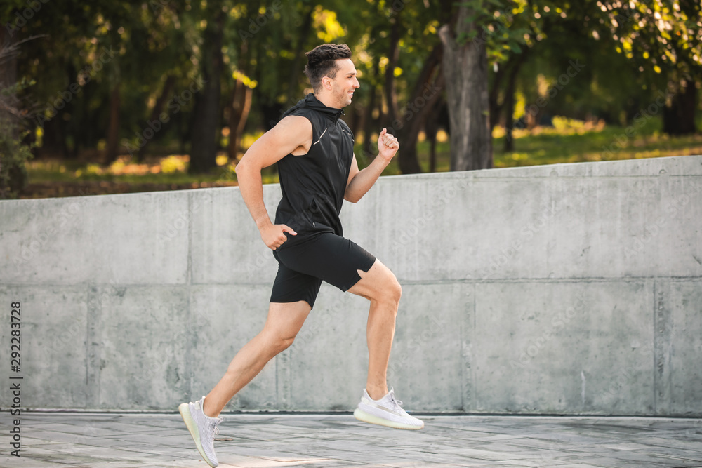 Sporty young man running outdoors Sporty young man running outdoors
