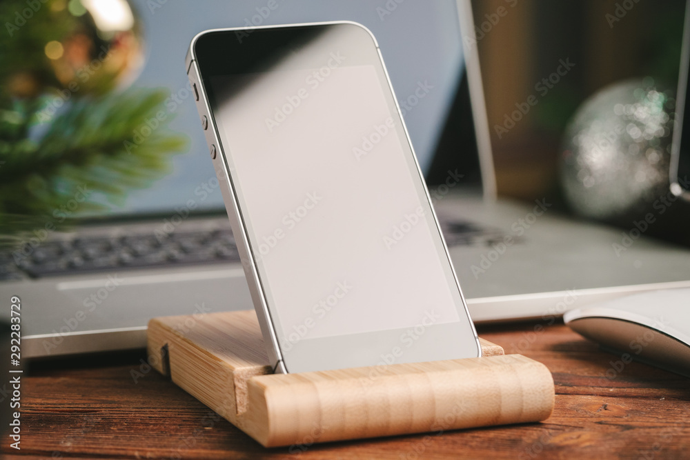 Close up shot of digital device on wooden table with christmas decorations Close up shot of digital device on wooden table with christmas decorations