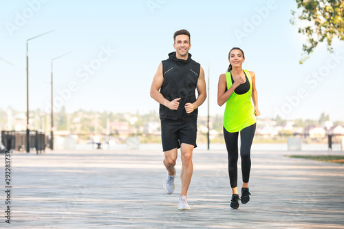 Sporty young couple running outdoors