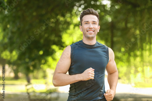 Sporty young man running in park