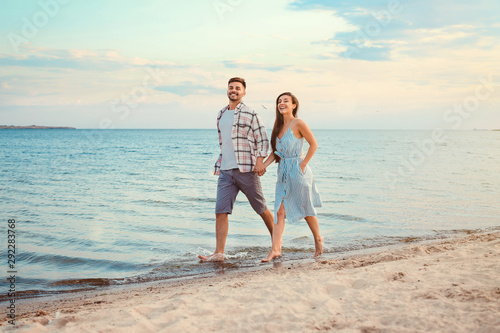 Happy couple running at sea resort