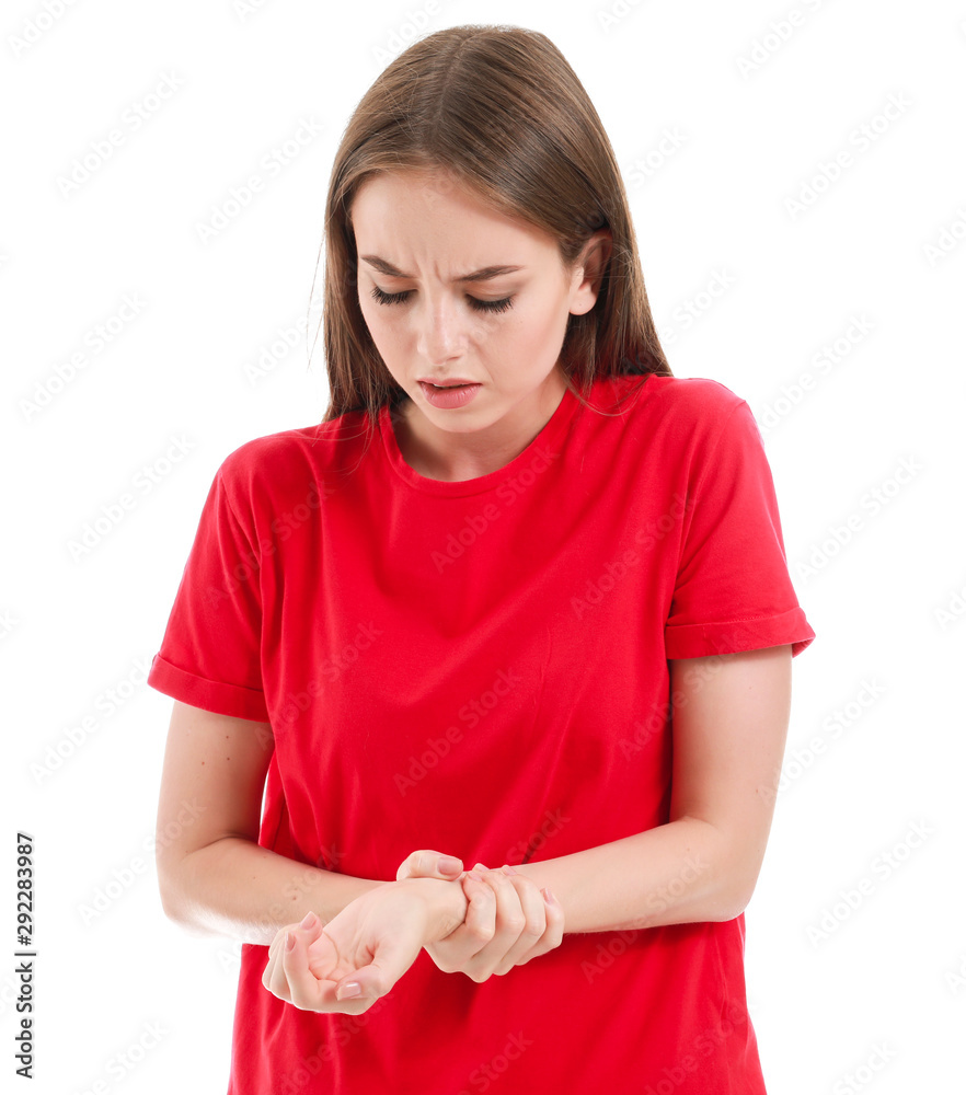 Young woman suffering from pain in wrist on white background Young woman suffering from pain in wrist on white background