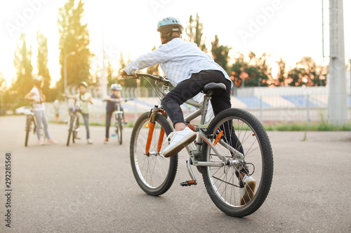 Cute children riding bicycles outdoors © Pixel-Shot