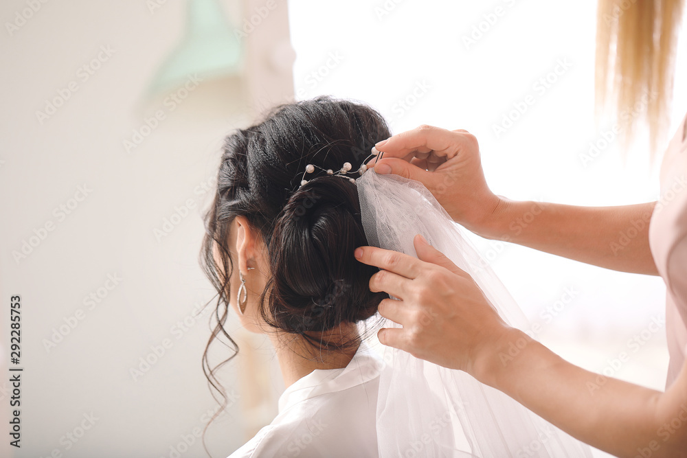 Professional hairdresser working with young Asian bride at home Professional hairdresser working with young Asian bride at home