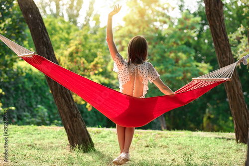Happy young woman sitting i...