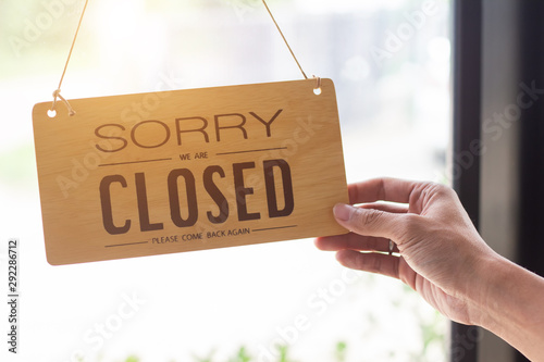 Close up sign hanging off Coffee shop door,Close sign blur background,Label word close
