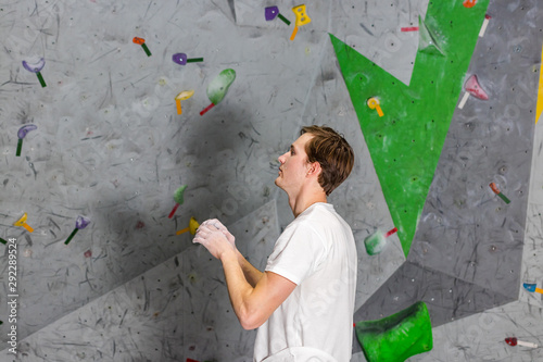 climber explores and develops a route on a climbing wall in the boulder hall