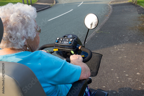 Elderly woman on a mobility scooter. 