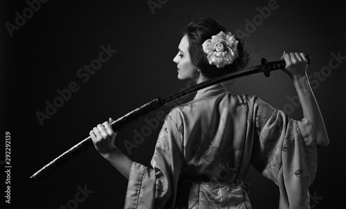Fotografie Attractive woman in traditional Japanese kimono with katana ( japanese sword)
