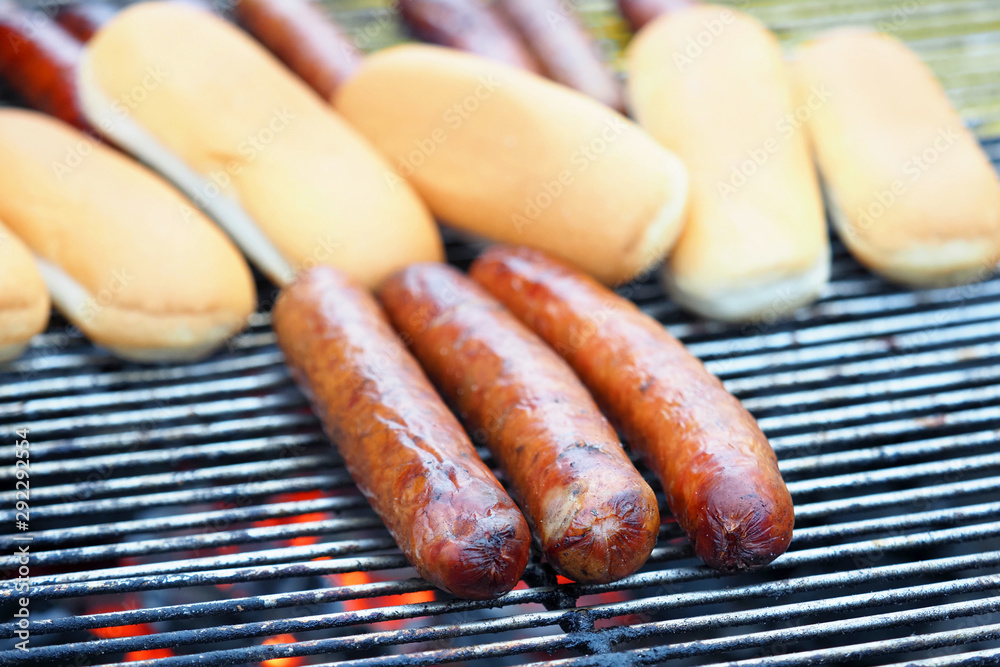 Cooking hot dogs, buns and sausages on the grill Cooking hot dogs, buns and sausages on the grill